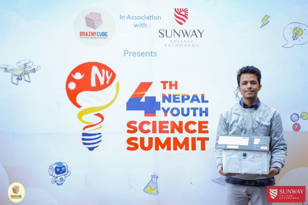 Prabin holding the face recognition prototype at the Nepal Youth Science Summit